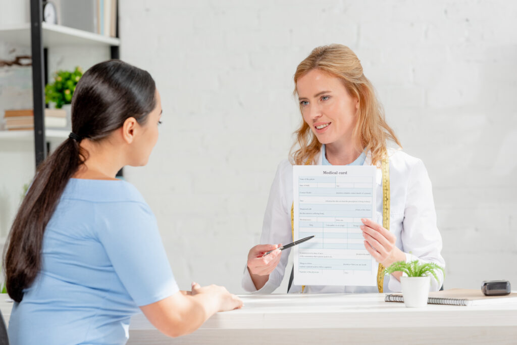 Nutritionist showing patient a medical card